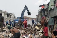 Sejumlah warga berburu besi bekas dari puing-puing bangunan yang dibongkar di bantaran Kali Apuran, RT 008/RW 012, Kelurahan Kapuk, Kecamatan Cengkareng, Jakarta Barat